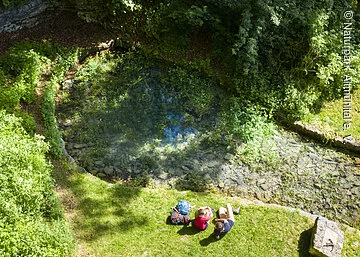 Wanderer an der Karstquelle Grüner Topf in Kipfenberg-Grösdorf